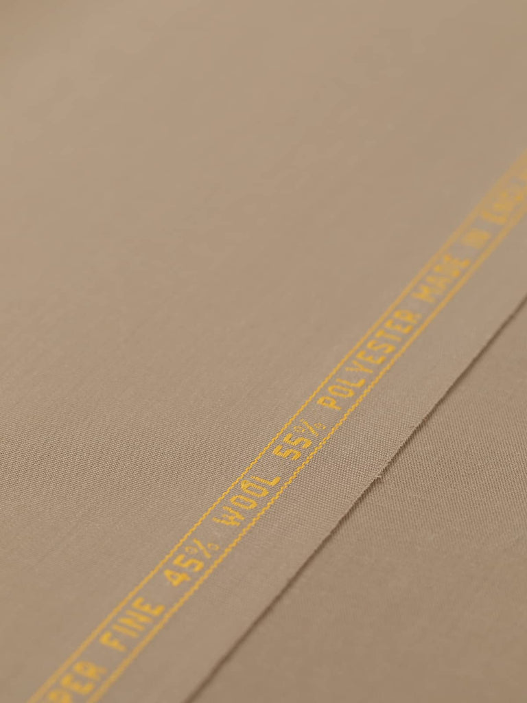 Flat, angled view of Golden Sand fabric, emphasizing its luxurious golden beige color and fine twill weave. The soft wool-poly blend ensures comfort and durability, making it a versatile choice for stylish, tailored pieces.