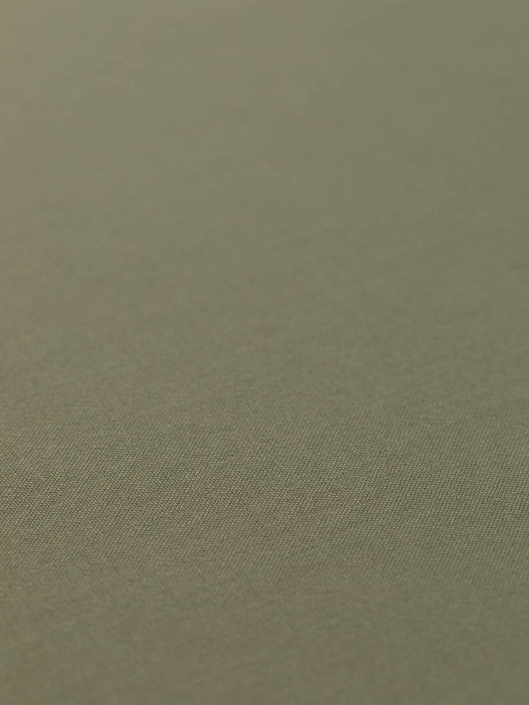 Flat, angled view of Dusted Olive fabric, capturing its superfine twill texture, all-over solid tone, and refined, understated style.