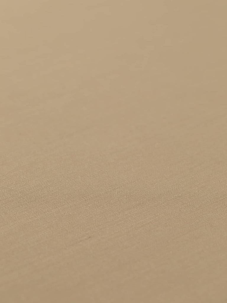 Flat, angled view of Priory Parchment fabric, capturing the refined gabardine texture, desert-sand inspired hue, and classic tailoring quality.