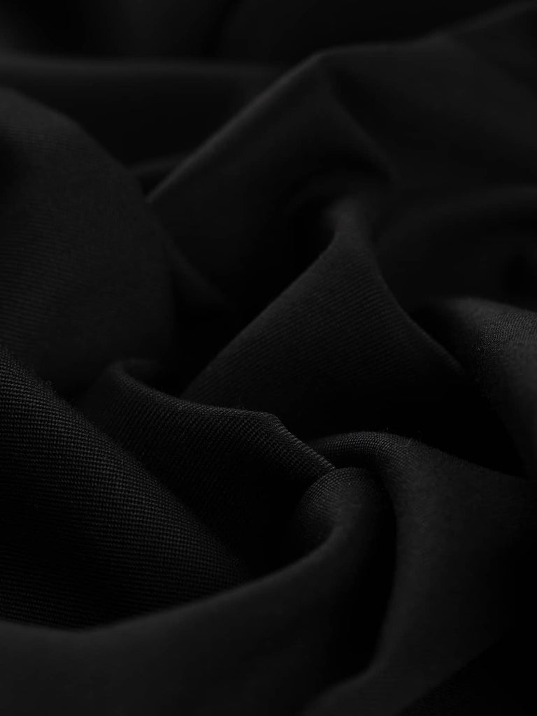 Angled twist shot highlighting the smooth, close gabardine twill texture of Serious Black fabric, showcasing its weighty drape and elegant finish.