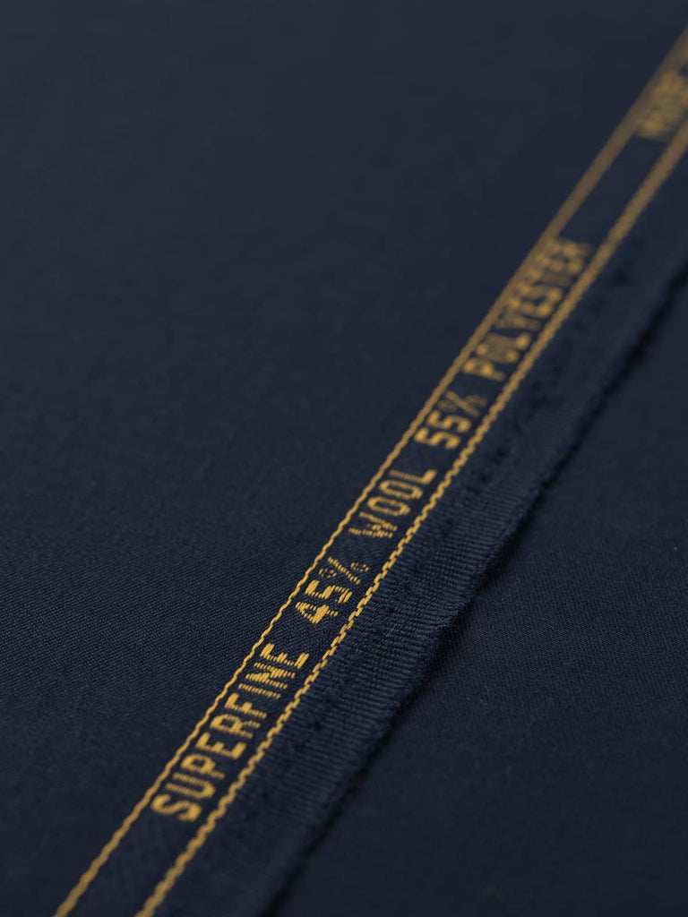 Flat angled view of Oxford Noir wool-blend twill fabric, highlighting its deep navy hue with black undertones, fine smooth surface, and elegant, weighty drape.