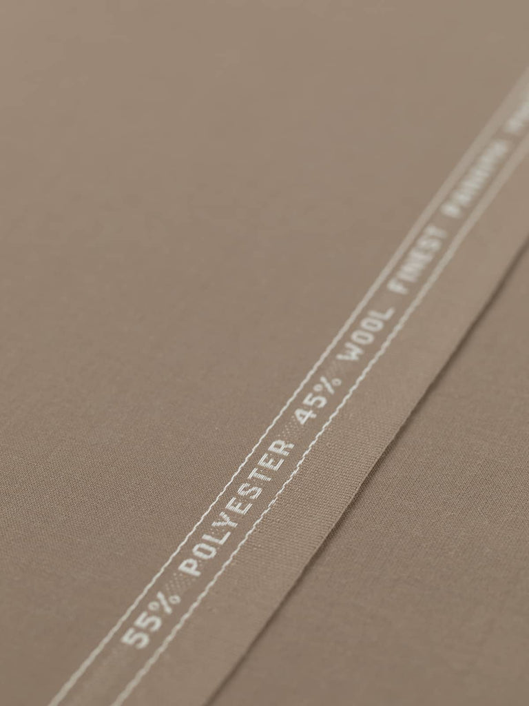 Flat angled view of Mocha Mousse superfine wool-blend worsted fabric, highlighting its warm beige-taupe color, crisp fine twill texture, and elegant, weighty drape suitable for structured silhouettes.