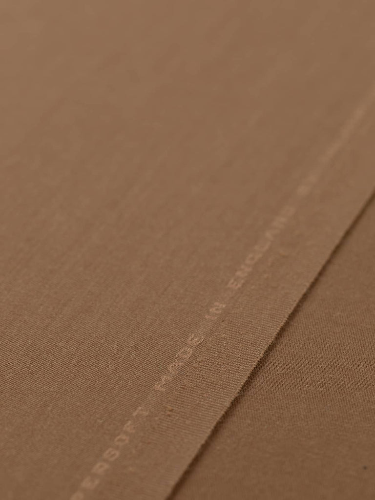 Flat angled view of Classic Tan wool-blend fabric, highlighting its refined twill gabardine texture, silky smooth handle, and versatile neutral tone.