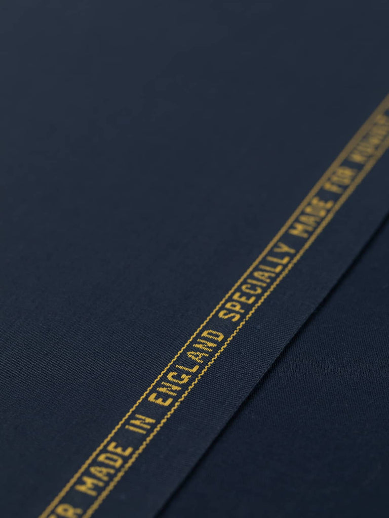 Flat angled view of Twilight Navy wool-blend twill, highlighting its refined worsted finish, crease resistance, and timeless deep blue tone.