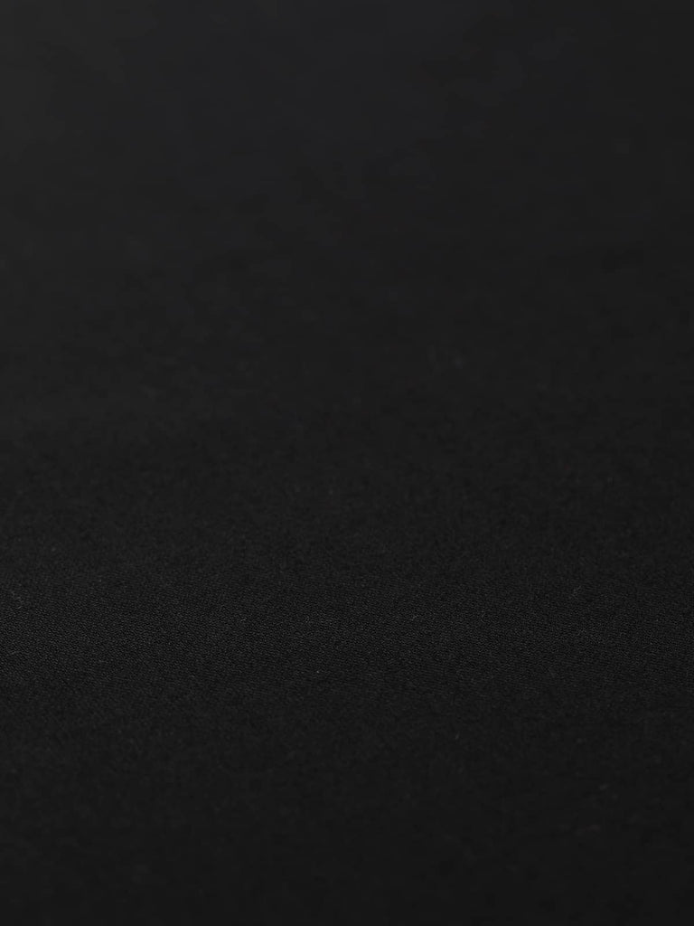 Flat angled view of Simply Black wool-blend twill fabric, highlighting solid black colour, fine worsted weave, and lightweight tailoring quality