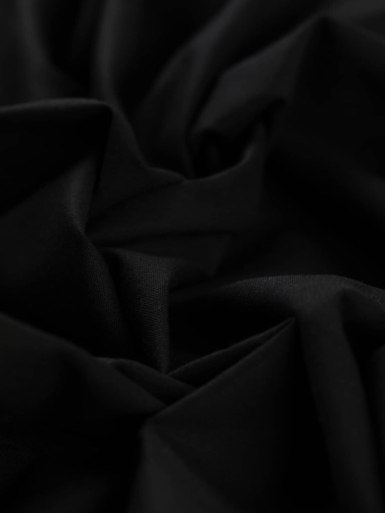 Twist of Simply Black wool-blend twill fabric, showing refined texture, stable handle, and elegant soft drape in timeless black tone