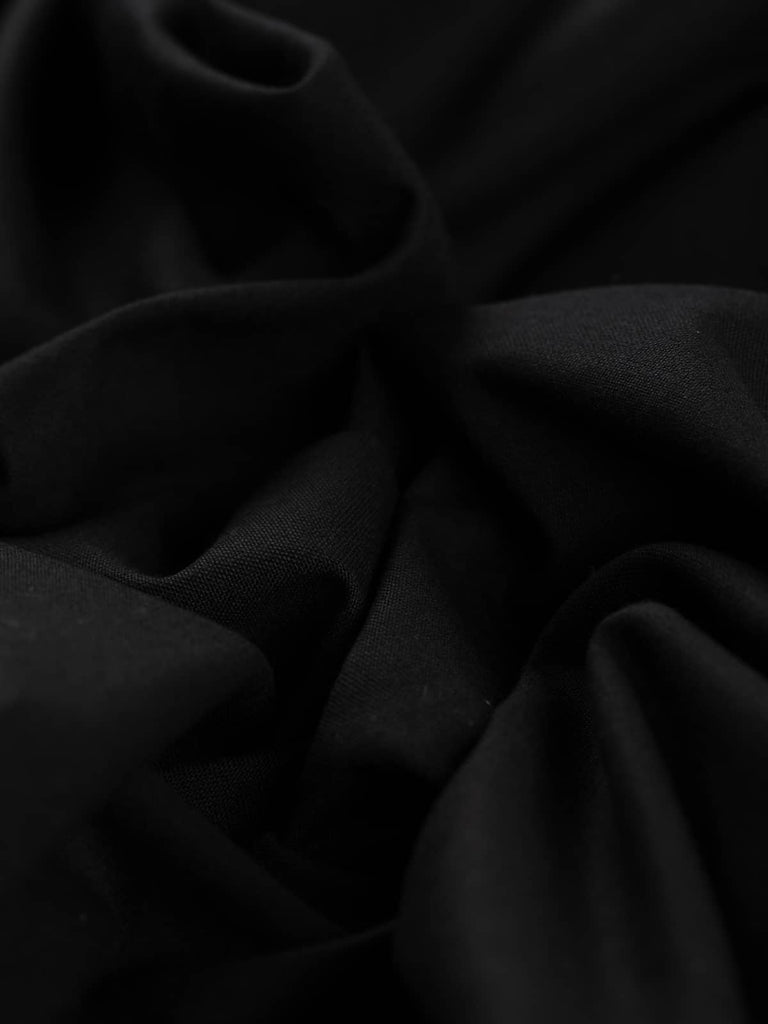 Twist of Simply Black wool-blend twill fabric, showing refined texture, stable handle, and elegant soft drape in timeless black tone