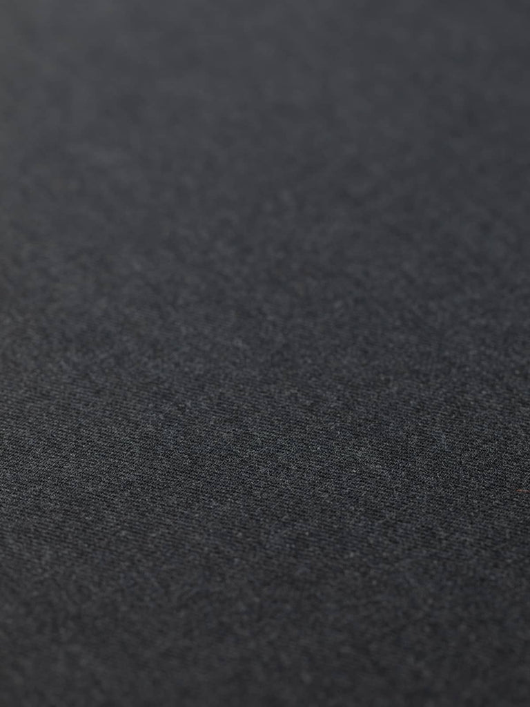 Flat angled view of Smoke Marl wool-blend twill fabric, highlighting marled grey colour, classic twill weave, and durable lightweight tailoring quality