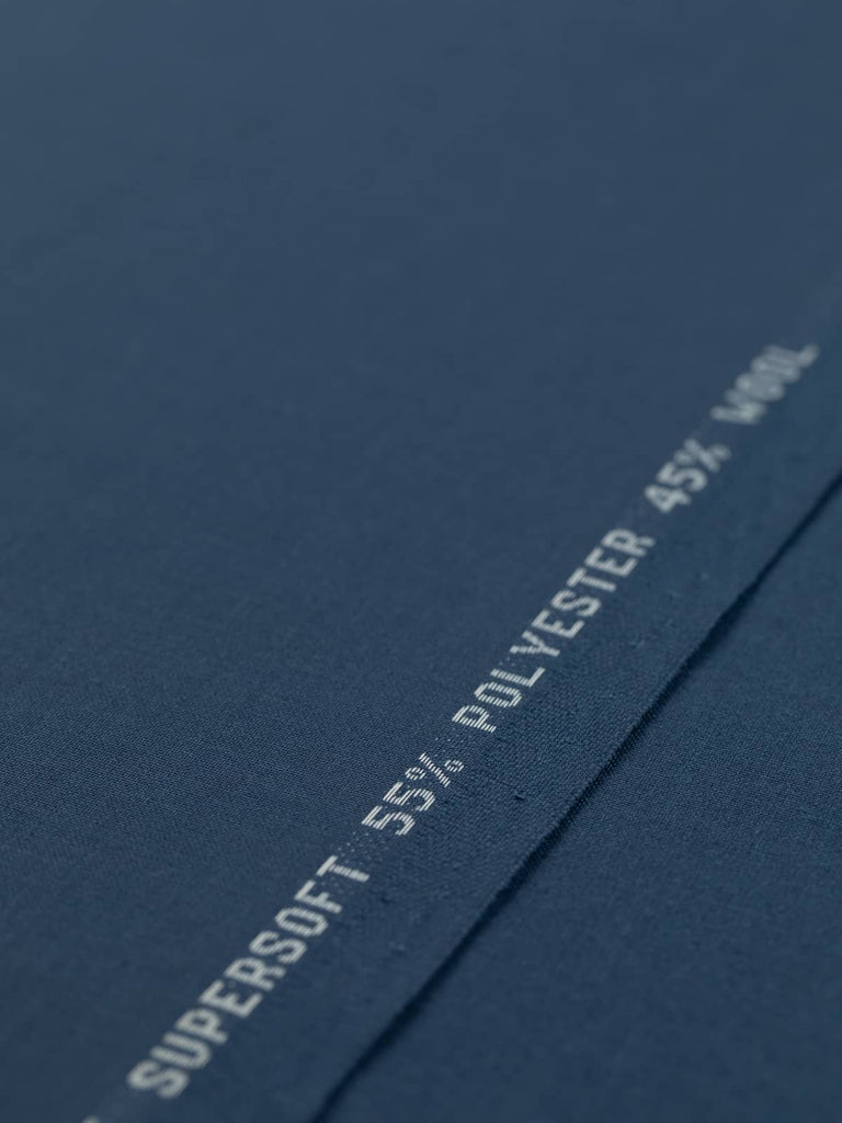 Flat angled view of Midnight Maritime wool-blend worsted fabric, highlighting its elegant French navy shade, crisp fine weave, and fluid drape for tailoring.