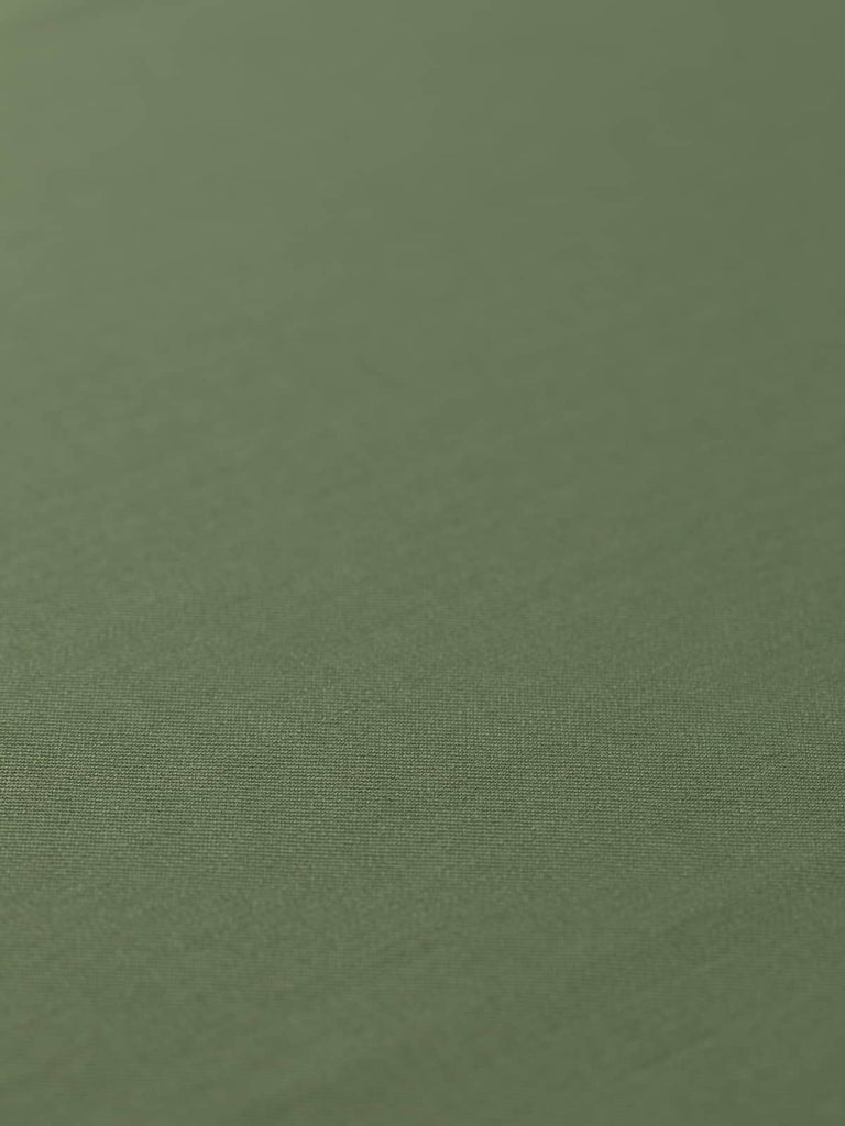 Flat angled view of Guardsman’s Green wool-blend twill fabric, highlighting its deep olive green colour, fine close twill weave, and versatile lightweight structure