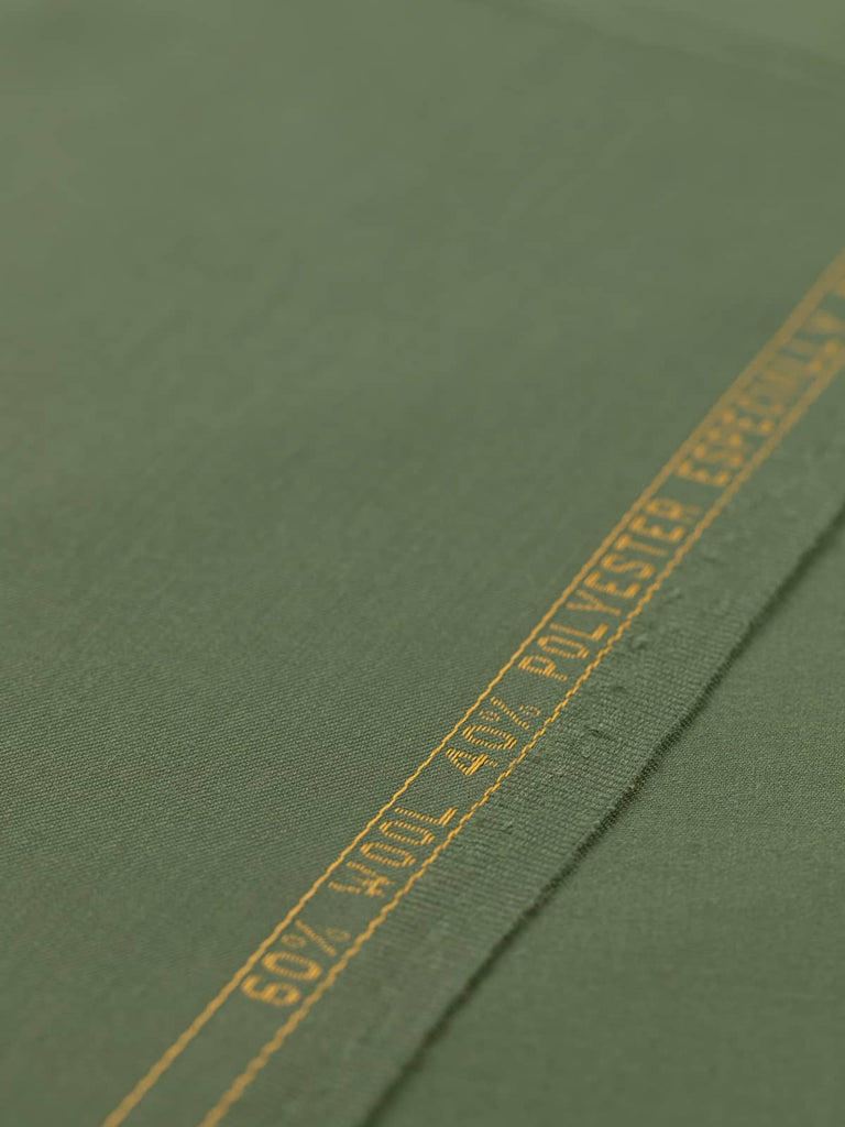 Flat angled view of Guardsman’s Green wool-blend twill fabric, highlighting its deep olive green colour, fine close twill weave, and versatile lightweight structure