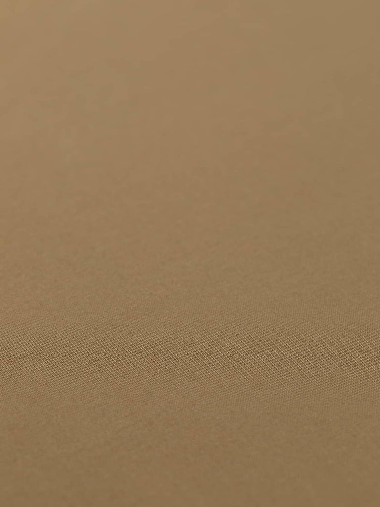 Flat angled view of Golden Hazel wool-blend worsted fabric, highlighting rich golden-brown tone, close worsted weave, and lightweight refined structure