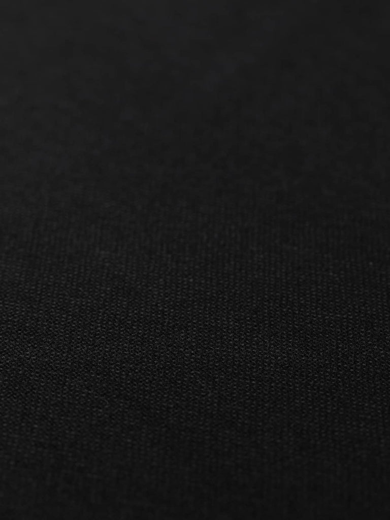 Flat angled view of Jet Weave wool Panama weave fabric, highlighting subtle basket-weave construction, rich black hue, and structured tailoring quality