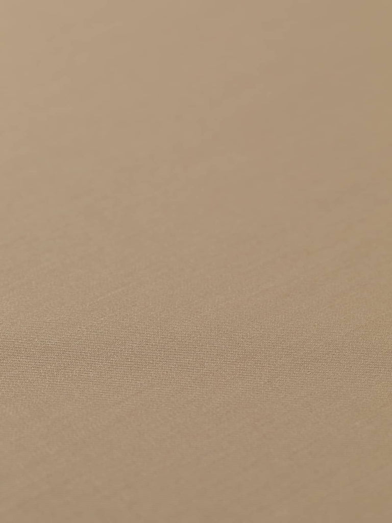 Flat angled view of Wheaten Gold wool twill fabric, highlighting fine weave, warm natural tone, and luxurious suiting quality