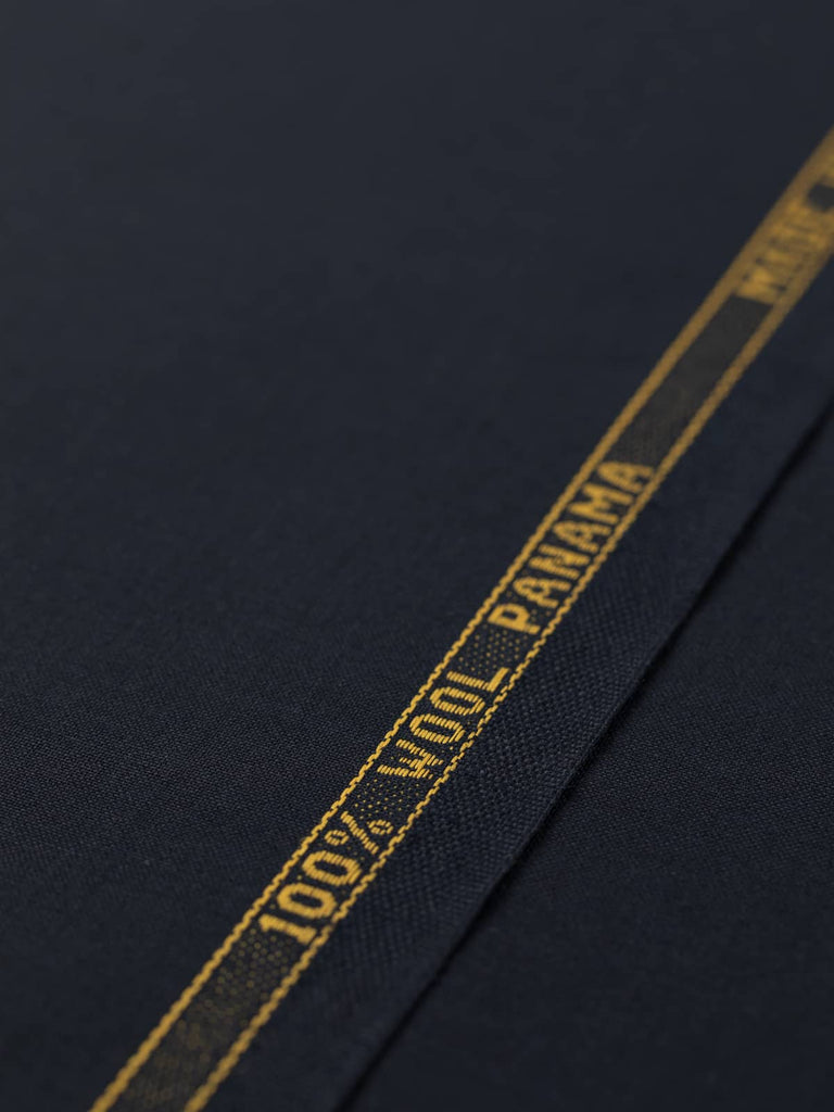 Flat angled view of Midnight Regent wool twill fabric, highlighting polished finish, classic solid hue, and luxurious midnight navy shade