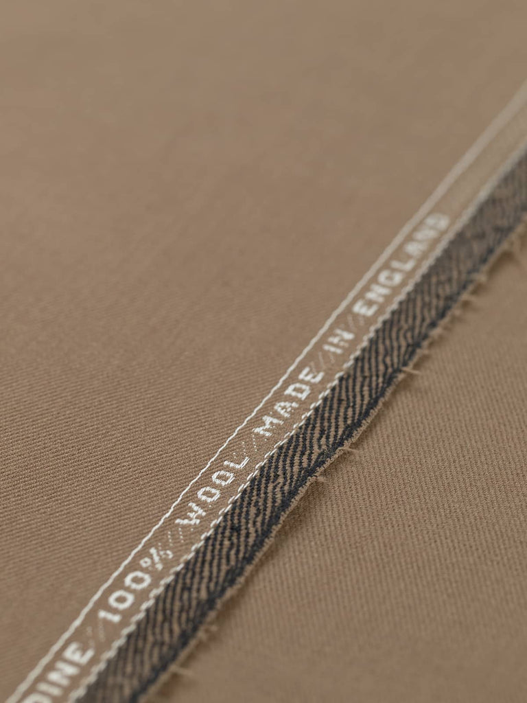 Flat angled view of Toasted Caramel wool twill fabric, showing refined finish, autumnal hue, and subtle lustrous sheen