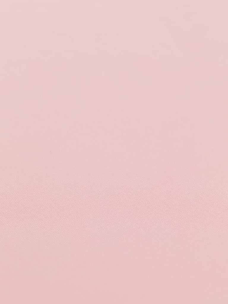 In a flat angle, the Ice Cream Pink fabric's fluid drape and gentle sheen are beautifully showcased. This medium-weight scuba fabric is ideal for simple yet stylish pieces like pencil skirts, skater dresses, and tunics, giving your wardrobe a refined pastel touch.