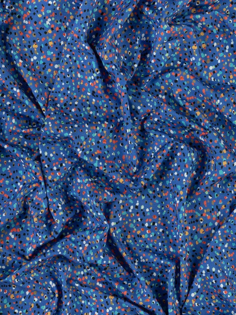 Blue jersey fabric with multicoloured spots for clothing 