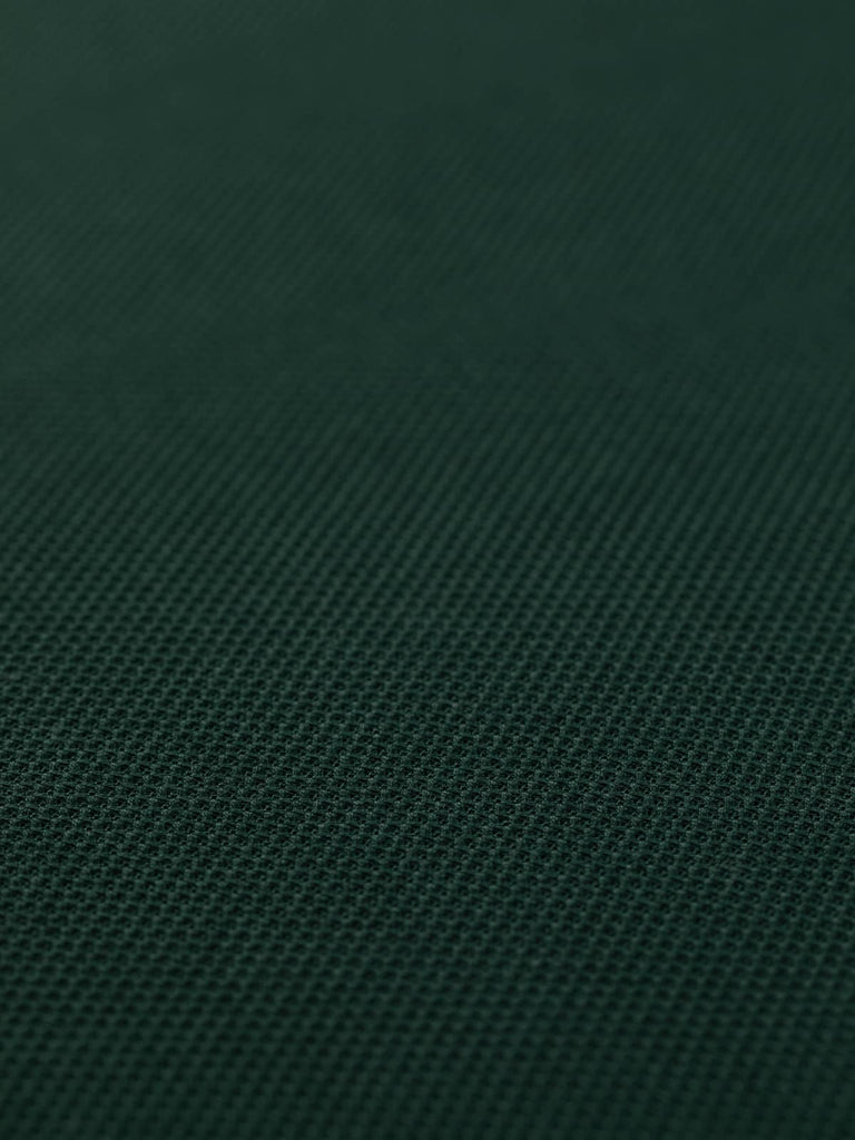 A flat view of the Pique Interlock Jersey in Green Peaks, revealing its intricate pique texture and smooth reverse side. The classic dark green color and flawless quality construction make it ideal for chic polo shirts and versatile casual wear.