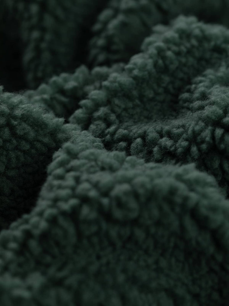 Detailed view of the Woodland Green Sherpa Fleece, capturing the fine, brushed fibres that mimic lamb fleece, showcasing the soft and cosy nature of the fabric.