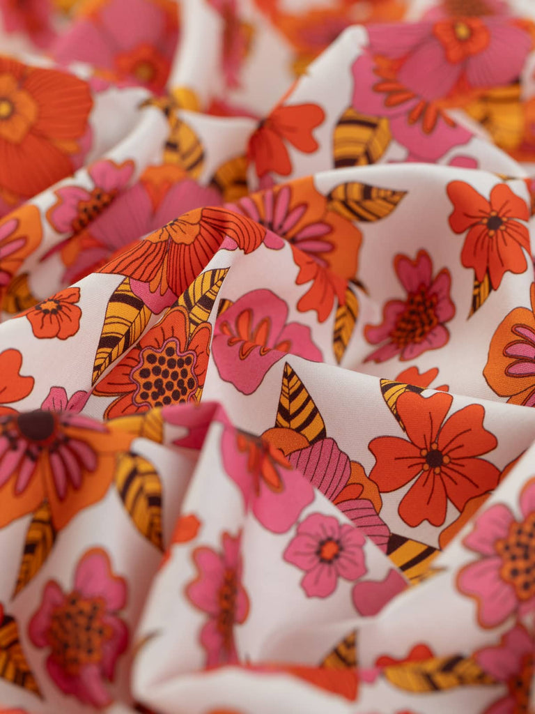 Orange and pink flowers print on white cotton fabric