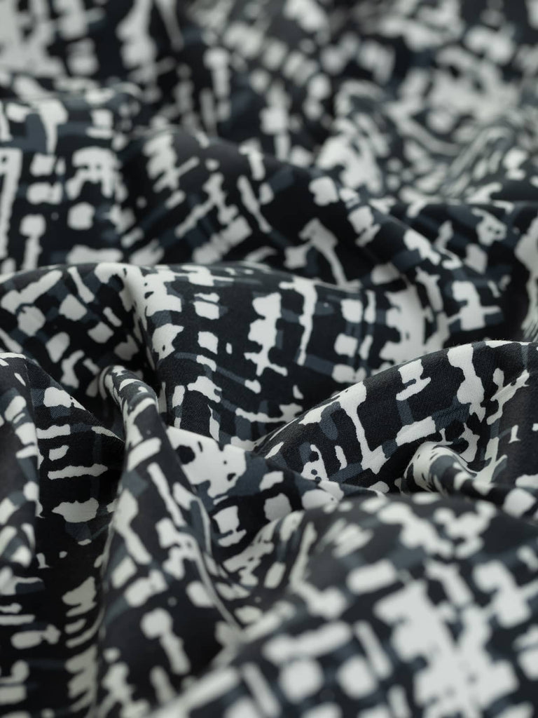 Angled image of black and white cotton for clothing