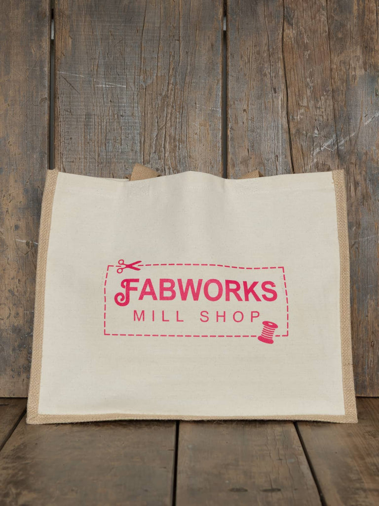 The Fabworks Tote Bag made from durable cotton and jute, showcasing its spacious rectangular shape and sturdy short handles.