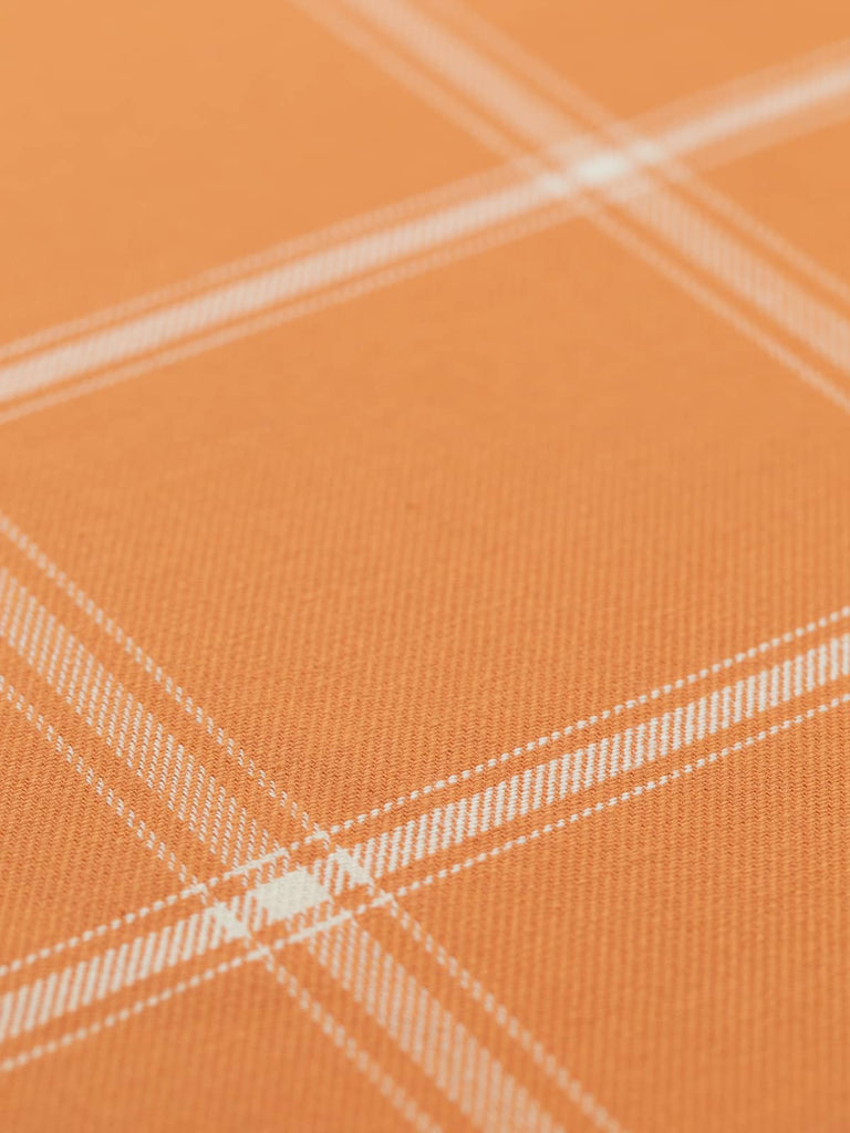 A smooth, evenly laid-out cotton twill fabric displaying its crisp windowpane check pattern. The cantaloupe orange background and fresh white intersecting lines create a classic picnic-inspired design, perfect for Mediterranean-style interiors, semi-structured garments, and stylish soft furnishings.
