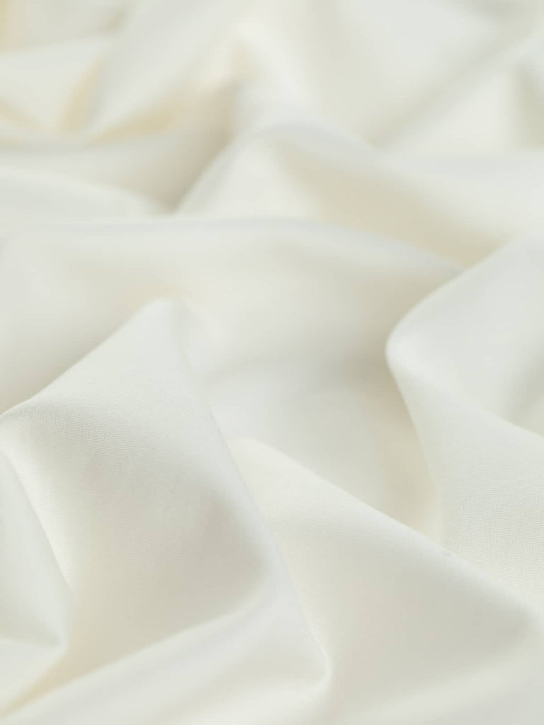 Silky Cotton Blouse Twill in Antique Ivory is a light, luxurious fabric with a classic pale cream tone, reminiscent of lustrous pearls. This fine Italian twill boasts a smooth, silky sheen, ideal for crafting elegant shirts, blouses, and luxurious sleepwear with a soft, breathable finish.