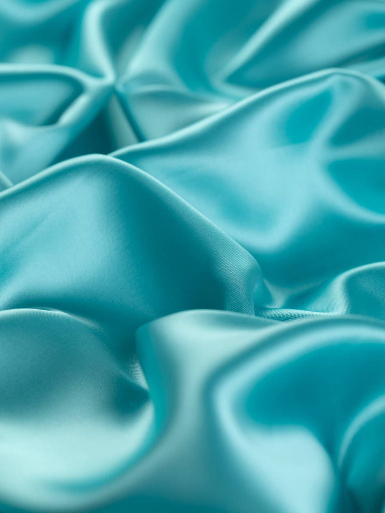 Elegant pastel turquoise satin fabric with a frosted lustrous sheen, 140cm wide, lightweight yet strong, perfect for classic tailoring and high-quality occasion wear