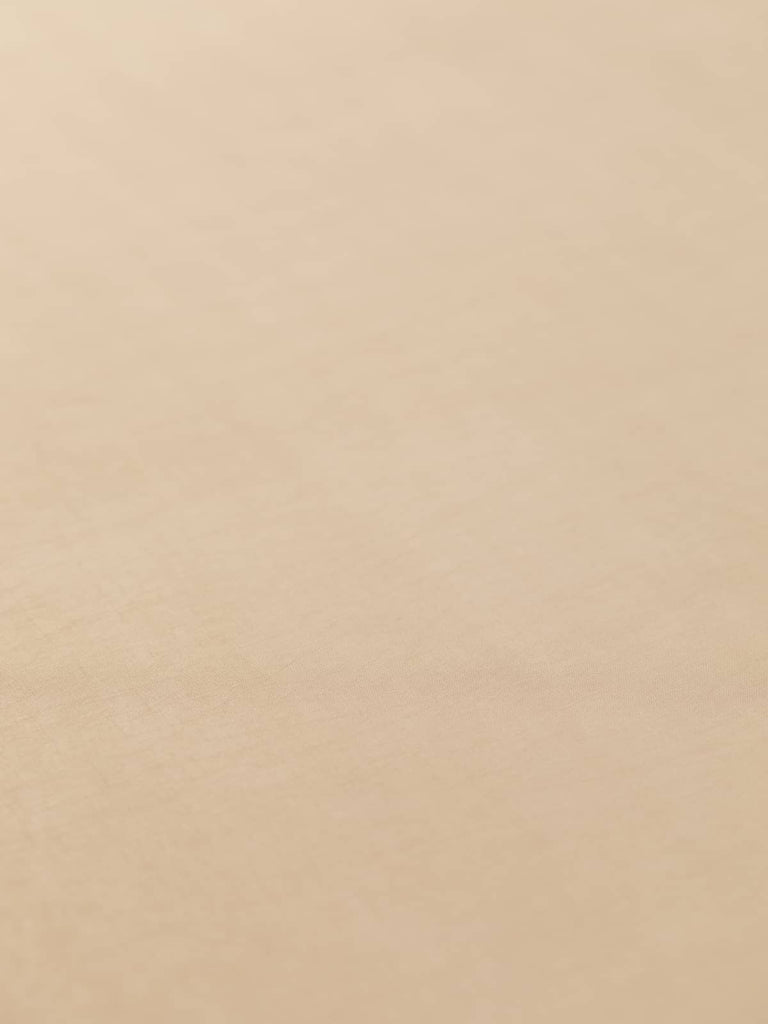 Elegant cupro fabric in soft warm beige with pink undertones, 130cm wide, offering a smooth, semi-matte finish and a cool silk-like feel, slightly translucent, perfect for lightweight jackets, skirts, and stylish corporate attire.