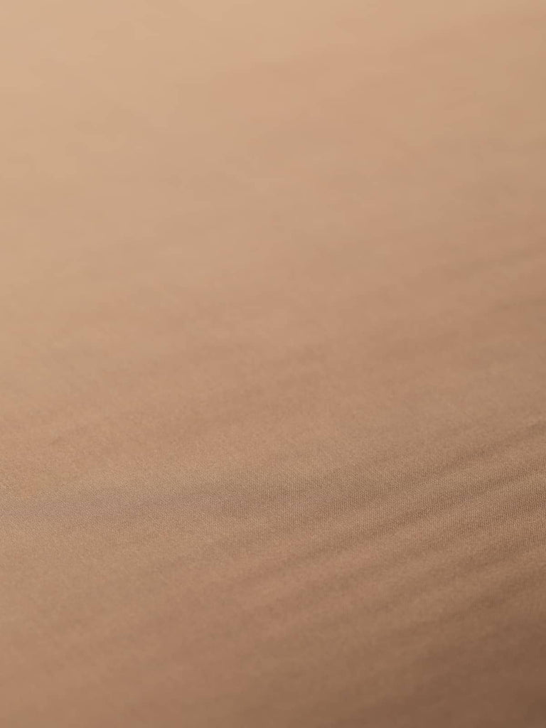 Elegant satin fabric in silky burnished soft brown, 142cm wide, offering a lustrous, smooth texture and cool feel, suitable for lining jackets, skirts, and dresses with its strong, stable composition.