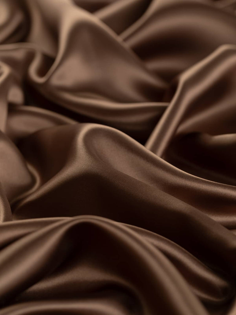 Light but strong acetate lining fabric, 142cm wide, in a solid fine satin weave, presenting a silky burnished soft brown with copper tones, perfect for classic tailoring and sophisticated occasion wear.
