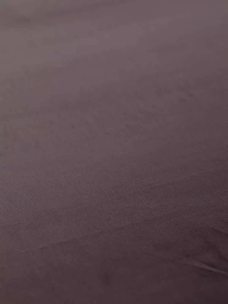 Elegant dark brown plum satin fabric, 144cm wide, featuring rich purple undertones. Made from a durable viscose and acetate blend, this fabric offers a silky, smooth texture and a subtle sheen, ideal for high-quality linings in coats, waistcoats, and accessories, and suitable as a premium satin outer fabric.