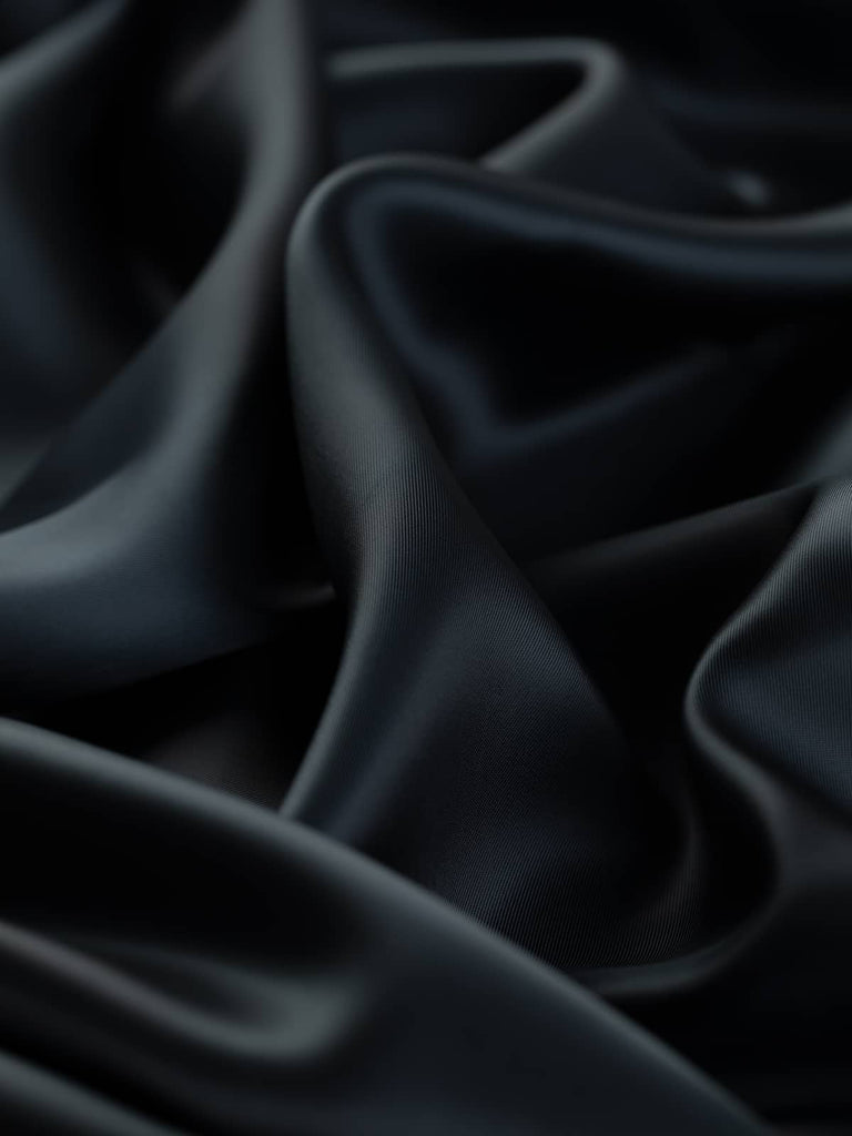 Darkest navy woven lining fabric, 140cm wide, crafted from an 80% viscose and 20% acetate blend in a superfine solid twill weave. This light fabric features a soft, silky texture with a high-shine, satin-like finish, perfect for lining jackets, dresses, and smart corporate attire with a drapey and cool feel.