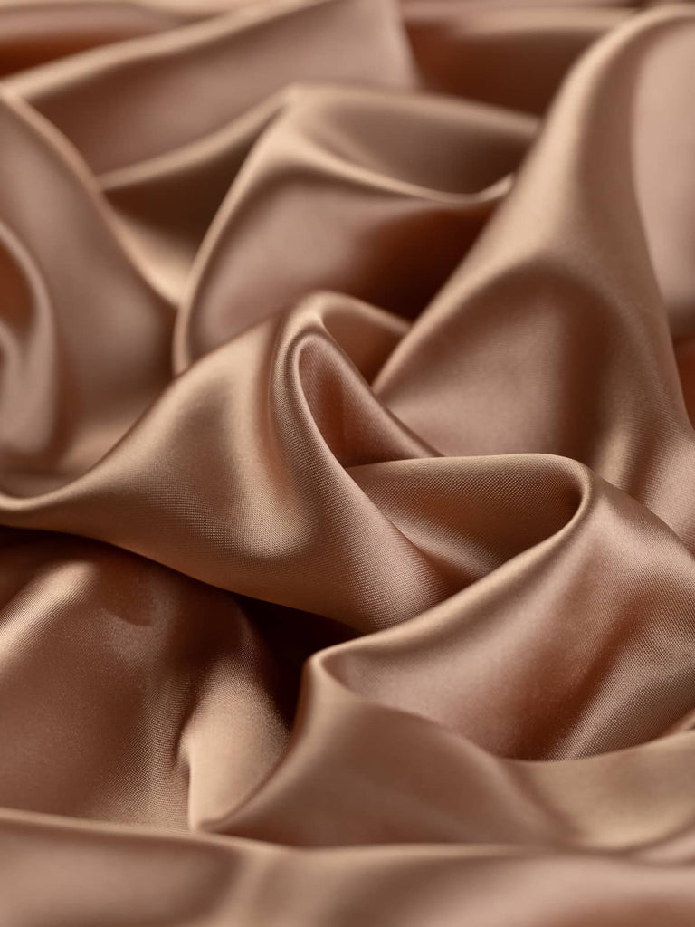 Silky burnished copper lining fabric, 144cm wide, featuring soft brown with subtle pink-rust tones. This light yet strong viscose and acetate blend offers a smooth, silky, and lustrous texture with a cool, drapey feel, perfect for lining jackets, skirts, and dresses, and also suitable as a premium satin outer fabric.