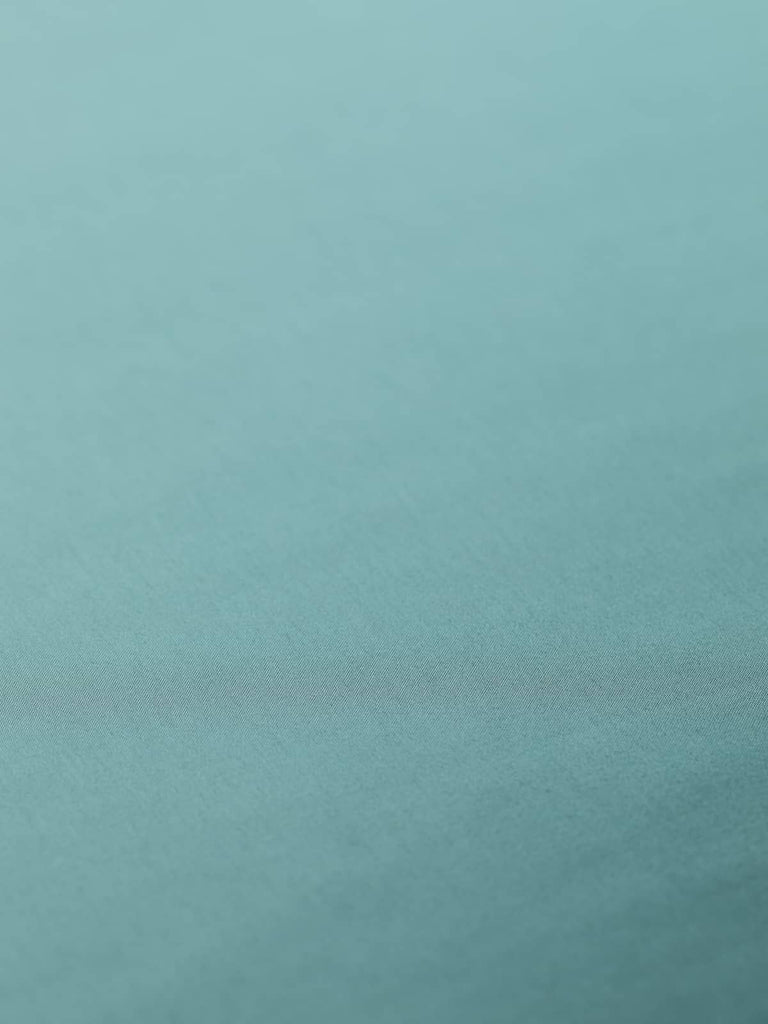 Silky washed teal blue-green lining fabric, 140cm wide. Made from 100% polyester with a superfine satin weave, this fabric offers a soft, lustrous semi-shine perfect for lining elegant garments and adding a cool, drapey feel to your designs.
