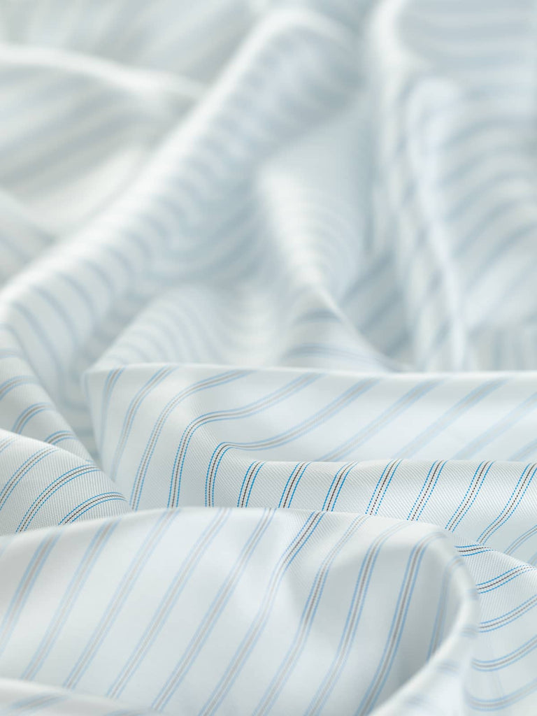 142cm wide Acetate and Viscose Lining fabric, featuring cool classic white with alternating black and lagoon blue stripes. Ideal for jackets, skirts, and coats, this lightweight fabric offers a soft, silky feel and a semi-lustrous finish.