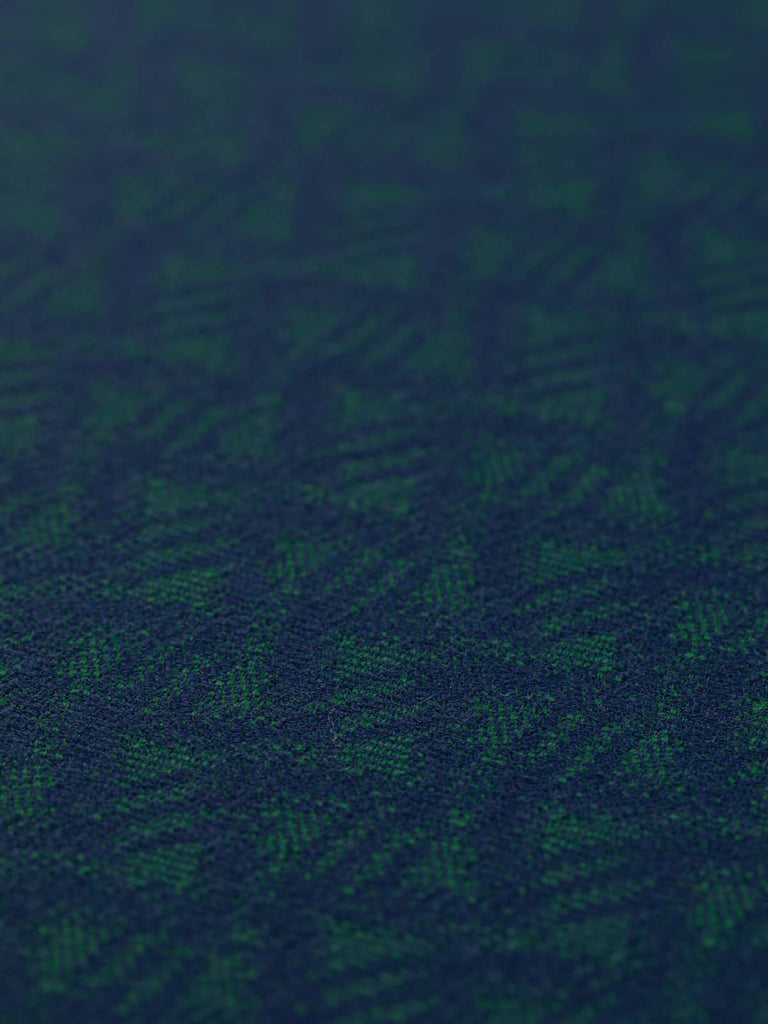 A flat angled view of the Oceanus Wave fabric displaying the calm, wave-like design. The close weave, vintage-inspired palette, and understated traditional style are highlighted across the grainy, tactile surface.