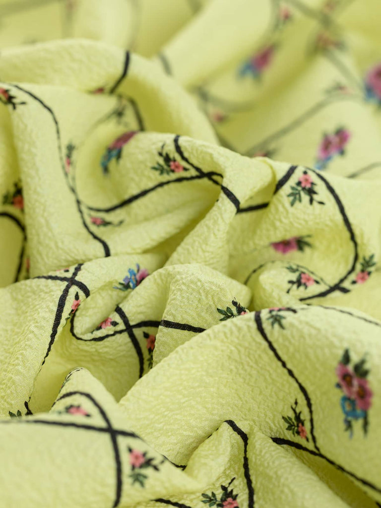 Yellow textured polyester crepe fabric with pink flowers 
