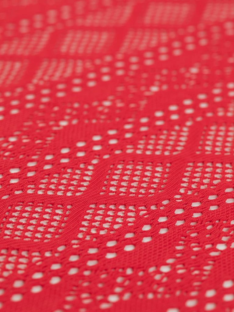 A flat view of the Extra Wide Stretch Mesh Lace - Sundance Red, capturing its bright, vivid pink-red color and wide width of 194cm. The medium weight and pattern repeat of 12cm are visible, with bold horizontal stripes and open lace areas creating a dynamic, fun summer fabric. Ideal for swimwear, festival wear, and creative accessories like embellished bags.