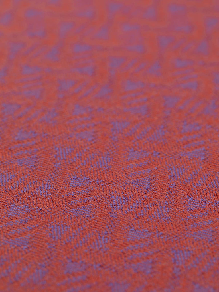 A flat angled view of Ispahan Wave fabric featuring the calm ocean-inspired jacquard pattern. The feminine colour palette and grainy surface texture lend a romantic, vintage charm to this heritage-style textile.