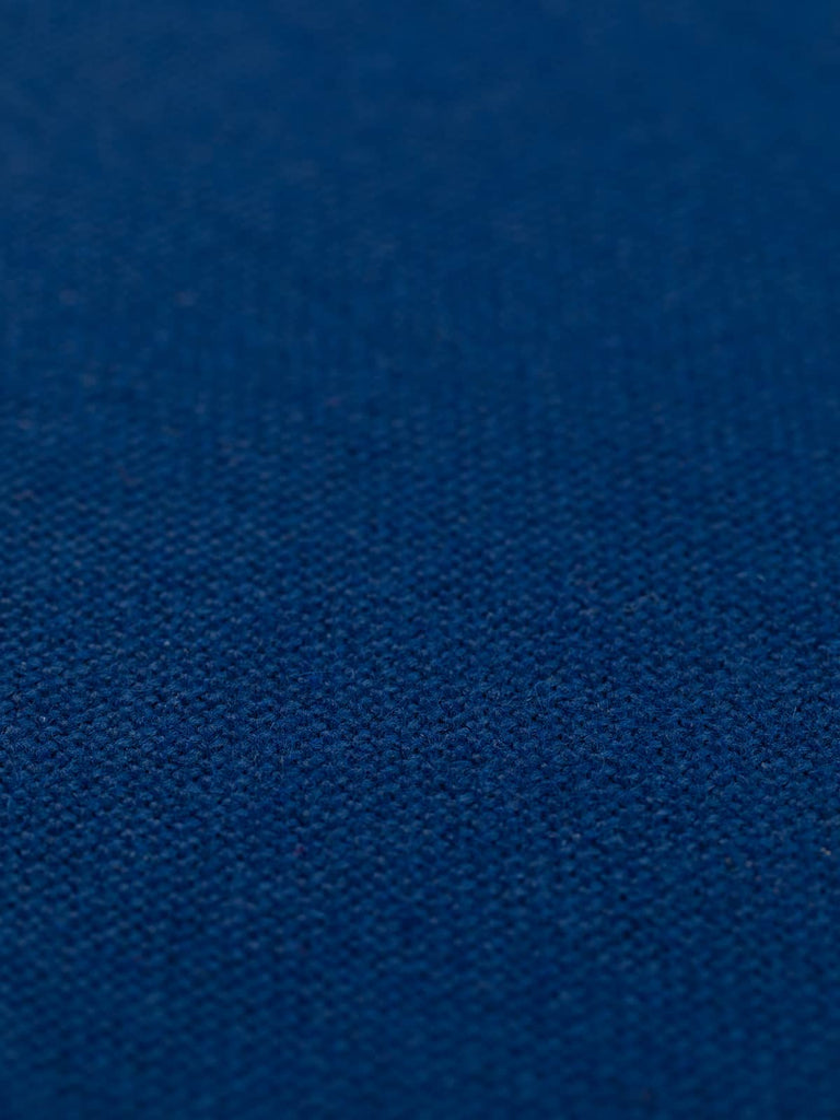 A flat angled view of Admiral Blue hopsack fabric, emphasizing the clean, solid colour and evenly textured feel. The fabric’s heavy drape and smart, timeless hue offer versatility for a variety of interior uses, from office to home design.