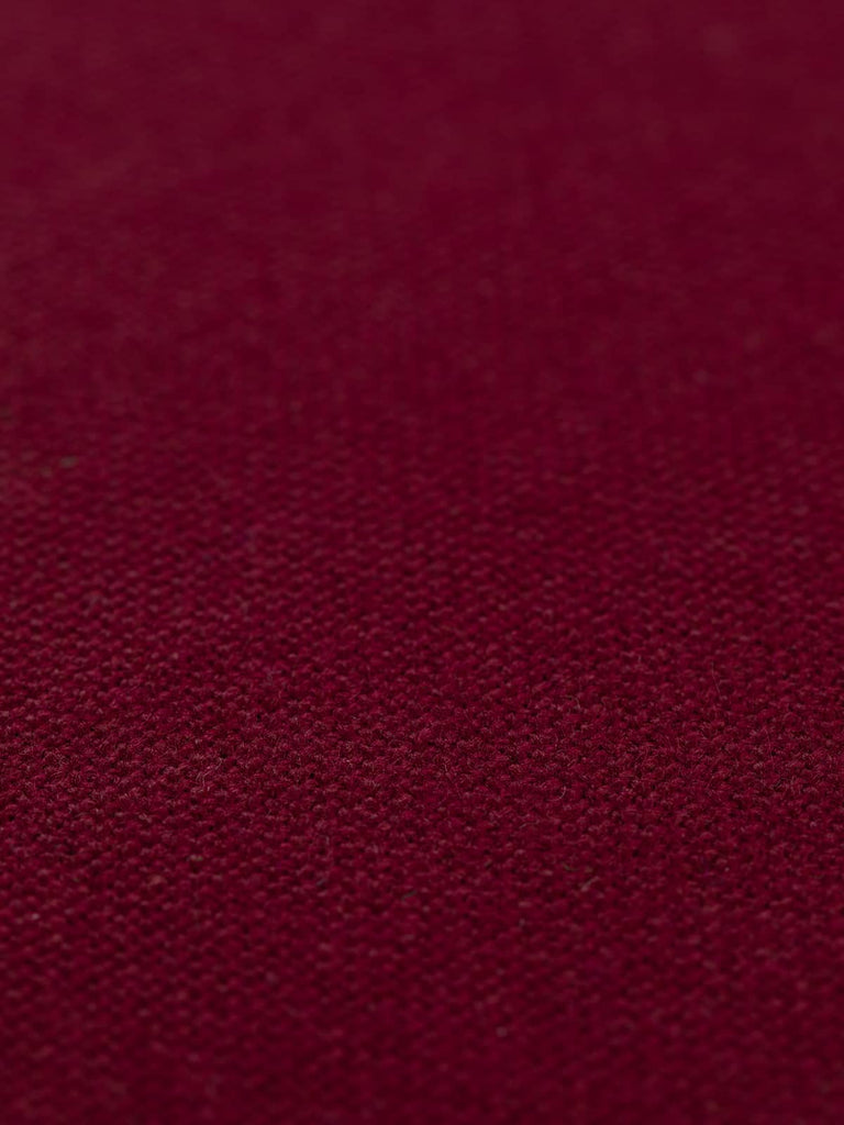 A flat angled view of Italian Cherry hopsack fabric, emphasizing the bold, jewel-like red hue. The tightly woven structure and heavy drape quality of the fabric create a rich, versatile textile suitable for both office and home environments.