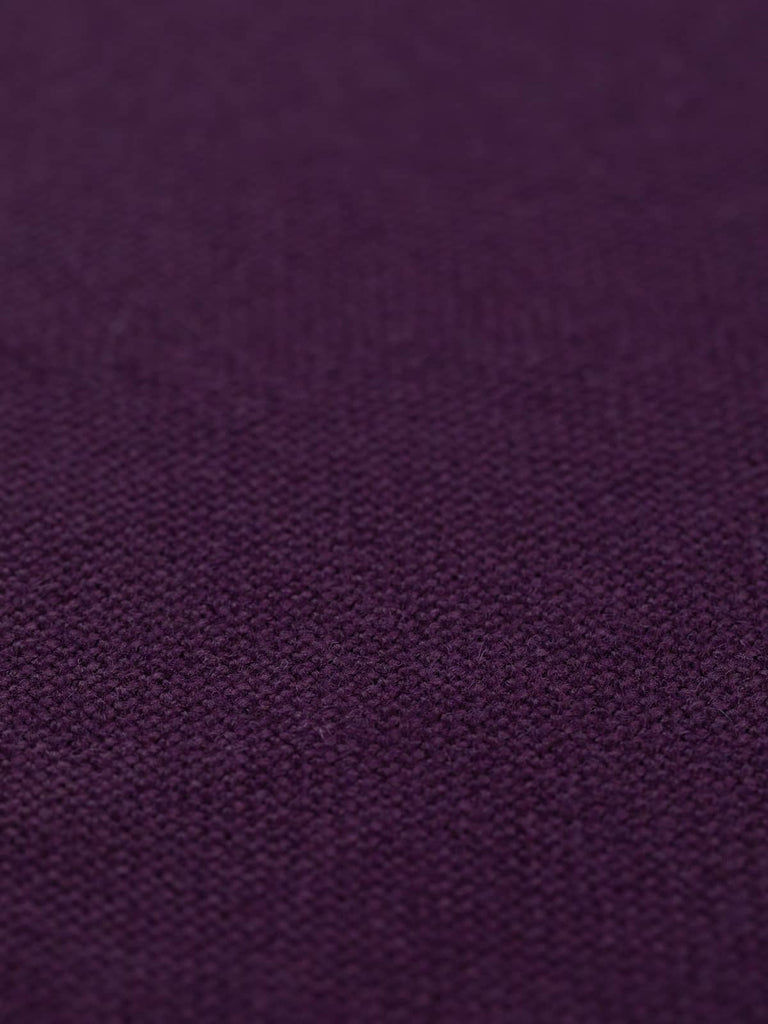 A flat angled view of Nightshade hopsack fabric, emphasizing its opulent dark purple shade. The fabric’s solid, rich colour and heavy drape quality make it a versatile choice for both office and creative interior designs, lending an air of sophistication and mystery.