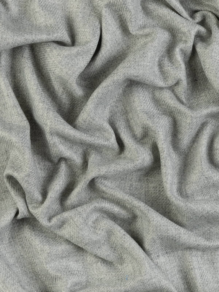 Twist of Fossil Sand Cashmere fabric showing reversible sides in fossil grey and sand beige, highlighting its luxurious sheen and fluid, snuggly drape.