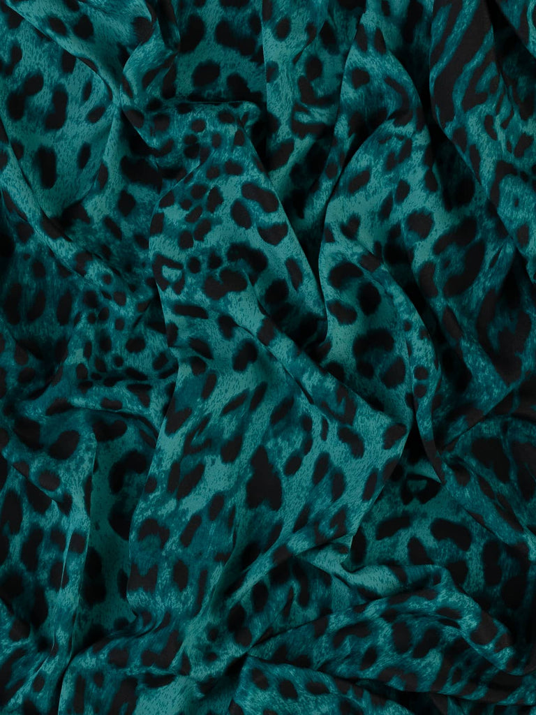 Leopard print on teal fabric for clothing use sewing