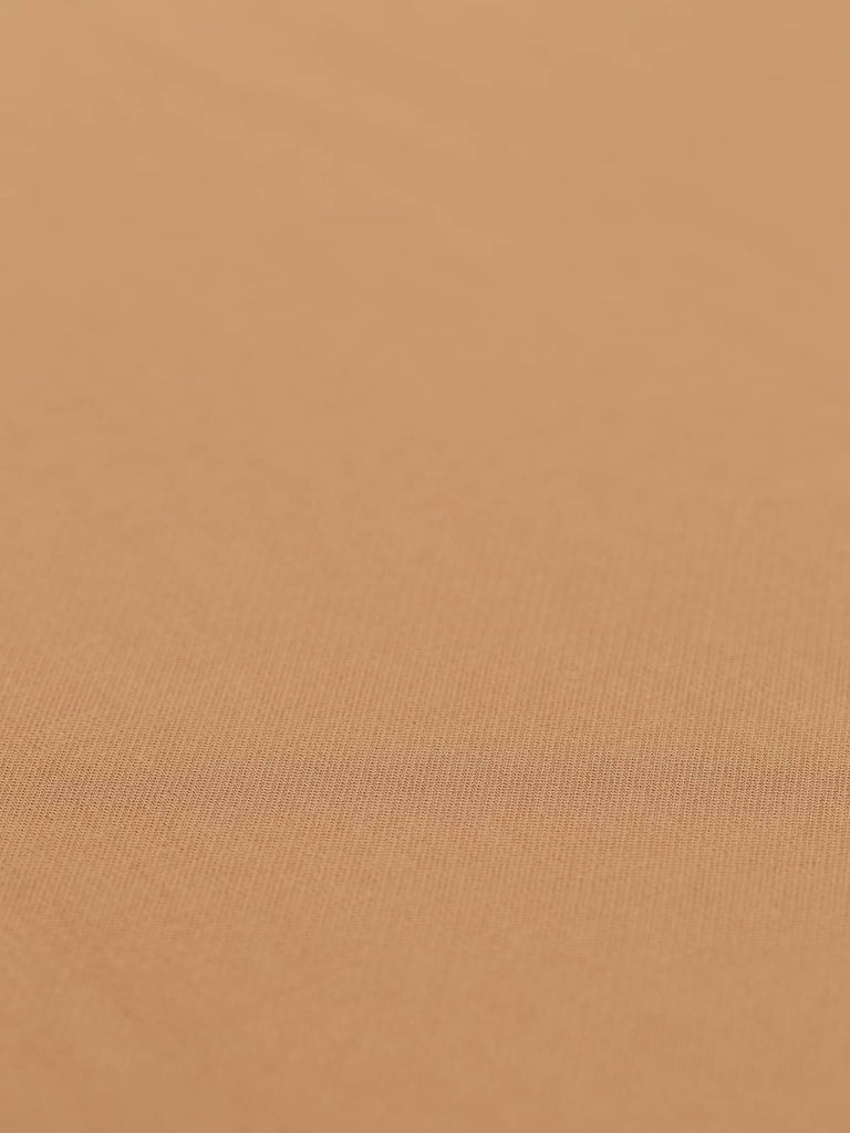 A flat view of the Lycra Viscose Twill - Caramel Gold, capturing its smooth and warm golden caramel color. The twill weave is clearly visible, emphasizing the fabric's medium weight and dense construction. With a width of 146cm, this fabric is perfect for creating tailored pieces like blazers, skirts, trousers, and dresses that drape beautifully and have a timeless appeal.