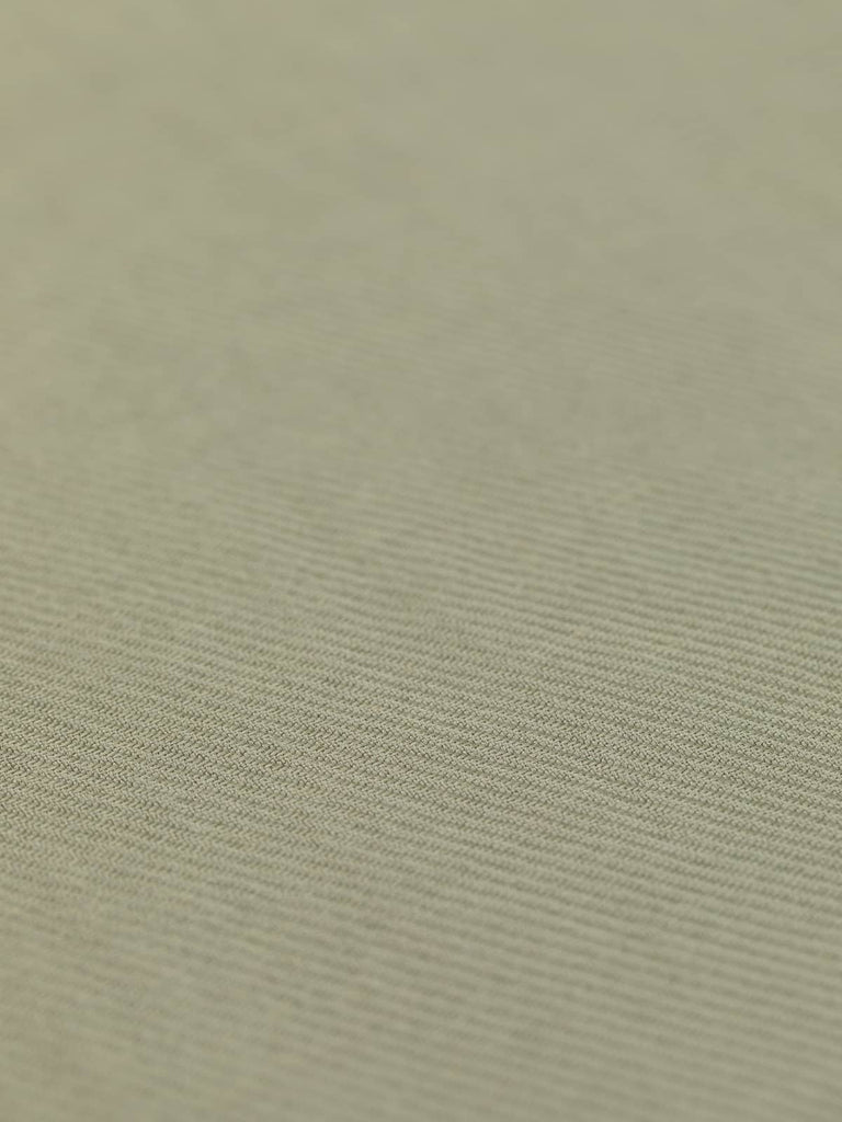 A flat view of the Chunky Viscose Twill - Herb Sachet, capturing the soothing natural green/beige color that evokes a sense of organic elegance. The clear display of the chunky twill weave underscores the fabric's stability and slightly textured surface. With a width of 158cm, this versatile fabric is perfect for creating a range of garments from blazers, trousers, and skirts to flowing overcoats and trench styles. Its cool, breathable feel.