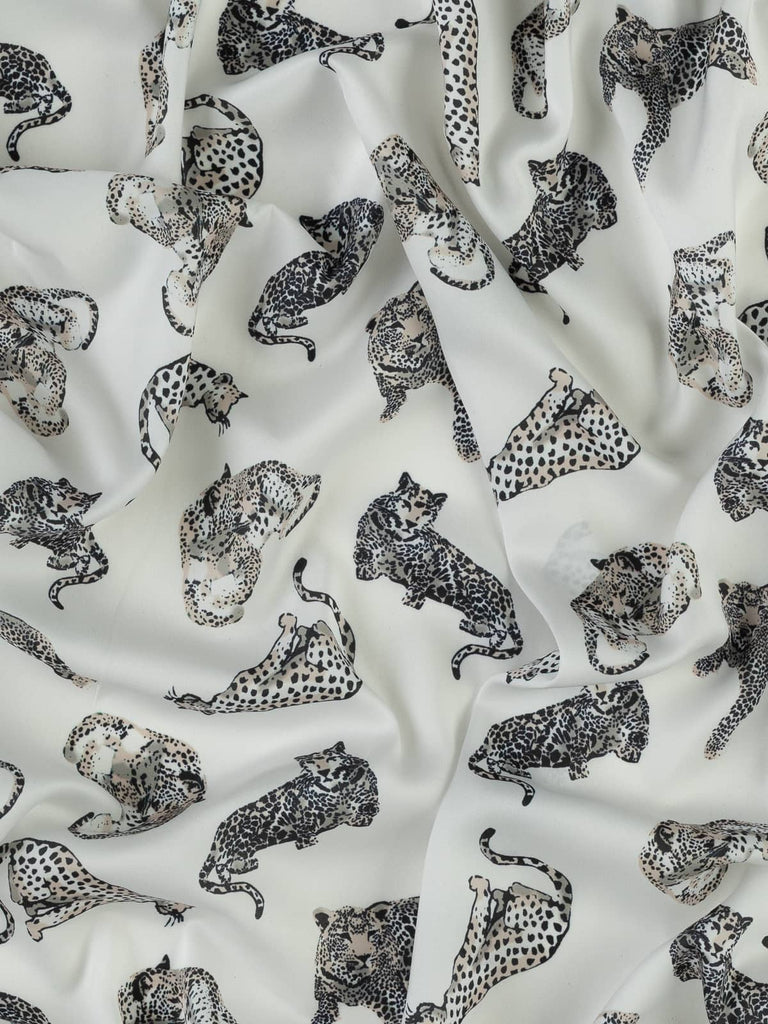 Off white polyester satin fabric with leopards for clothing